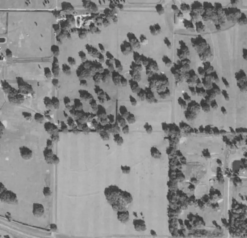 Aerial map of a rural parcel with its boundary outlined and four numbered comparable sales around it